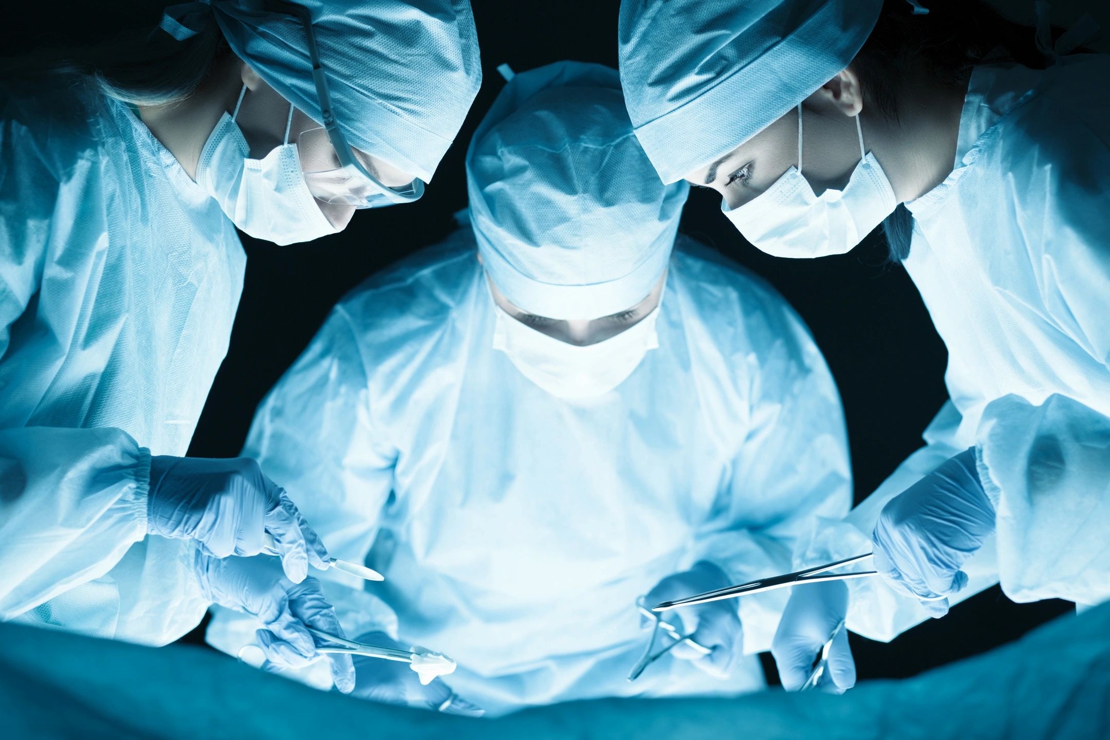 Doctors performing complex surgery